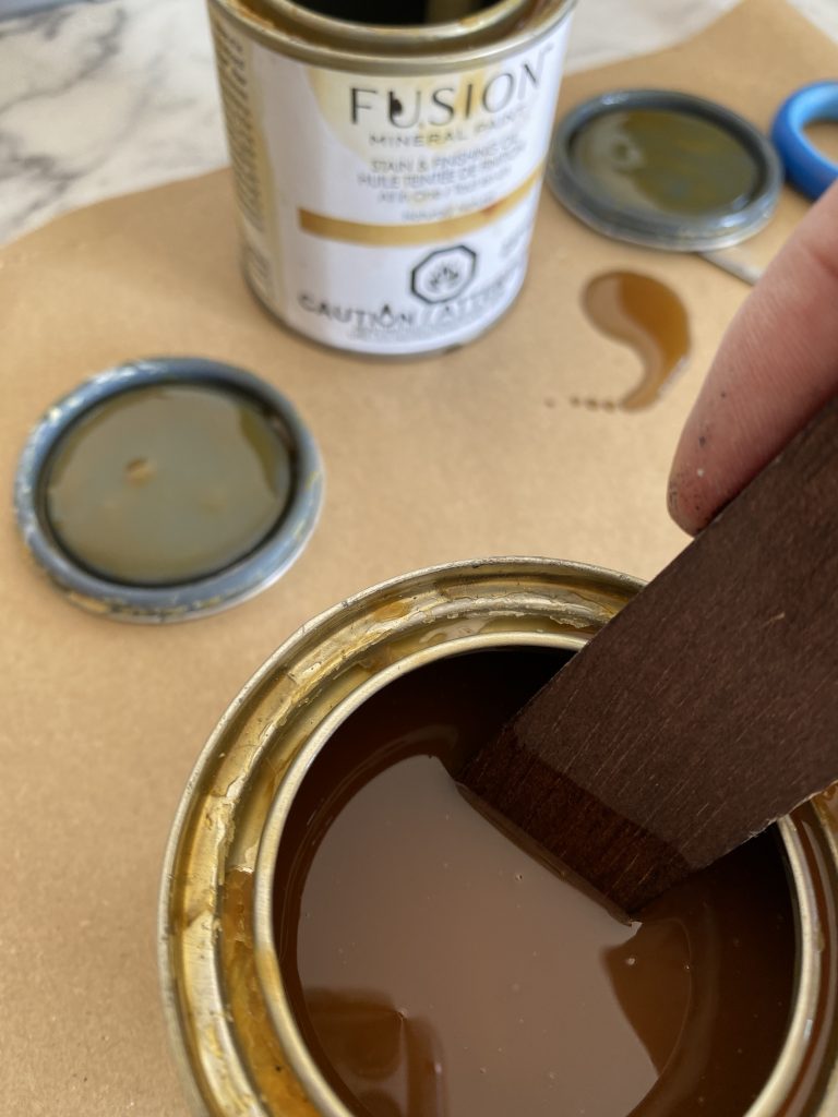 Stirring a can of Stain and Finishing Oil 